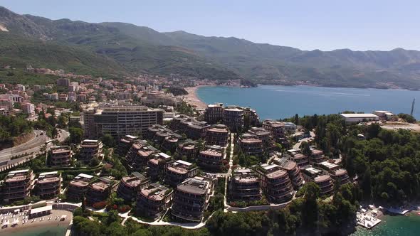 Peninsula with Hotel Dukley Next to the Sea Against the Backdrop of a Highway with Driving Cars