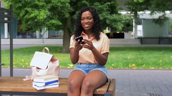 African Student Girl with Smartphone in City