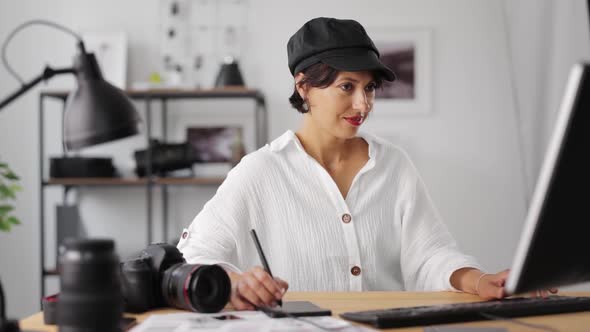 Photographer Processing Pictures at Office