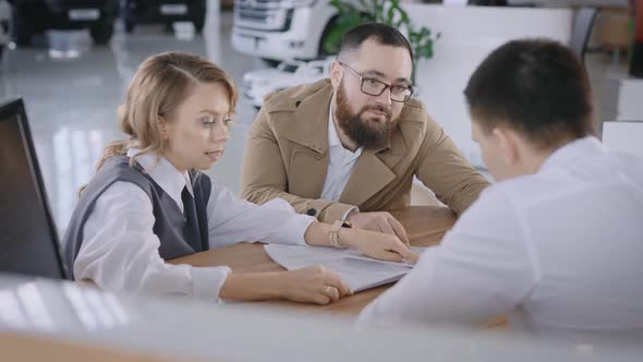 A Married Couple Buys a New Car in a Car Dealership