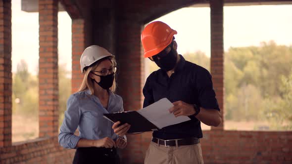 Two Engineer In Helmet Inspecting Building. Builder Contractor Specialist Read Home Plan Scheme.