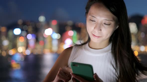 Woman use of mobile phone at night