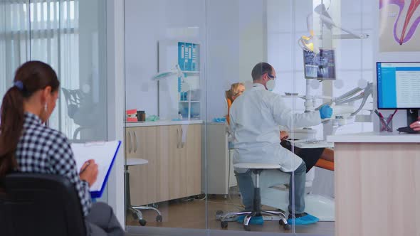 Orthodontist Lighting the Lamp Until Examination