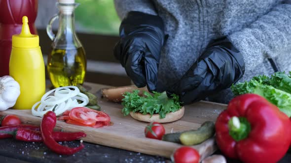 Putting a Fresh Salad on a Half of Grilled Burger Bun