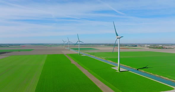 Wind turbines generating electricity in a flat Dutch landscape.