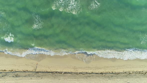 Sea with Waves and Sandy Beach in Sunny Morning