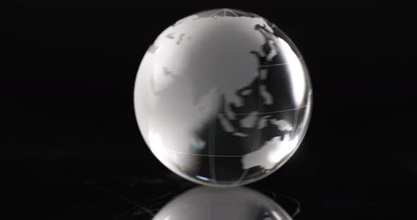 Glass Transparent Ball Globe is Spinning on Black Background
