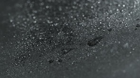 Super Slow Motion Shot of Water Droplets Splashing on Waterproof Cloth at 1000Fps