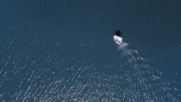 One small sailing boats on the blue lake