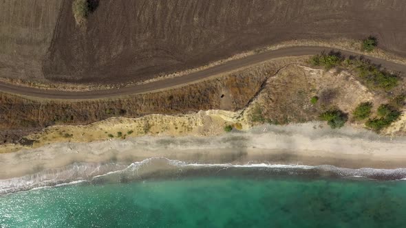 Aerial view to a steep sea shore and sand beach