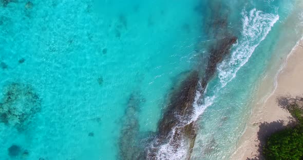 Natural fly over travel shot of a sunshine white sandy paradise beach and blue sea background