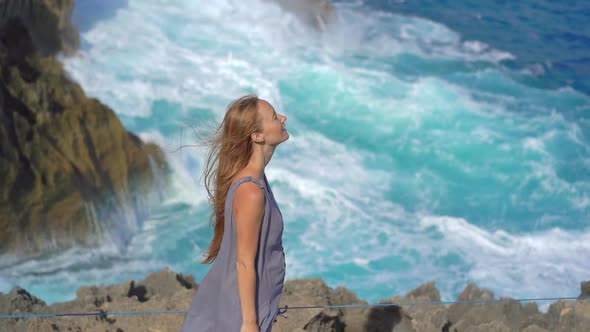 Young Woman Tourist Visits the Angel's Billabong Beach at the Nusa Penida Island Where Huge Waves