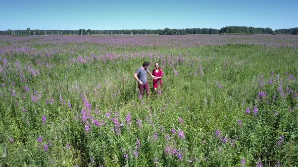 Couple in Love Move Fast Crossing Beautiful Blooming Field