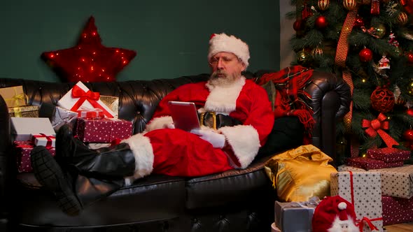 Santa Claus Communicates By Video Call Using Tablet
