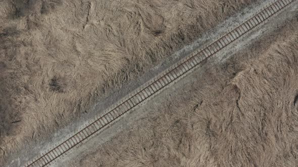 Rotating above railroad track in wild 4K aerial footage