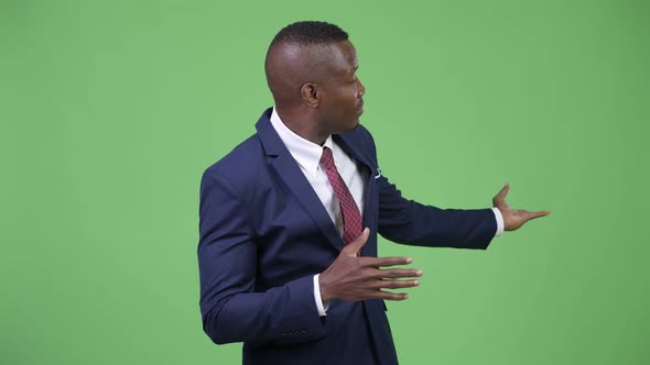 Young African Businessman Presenting Something