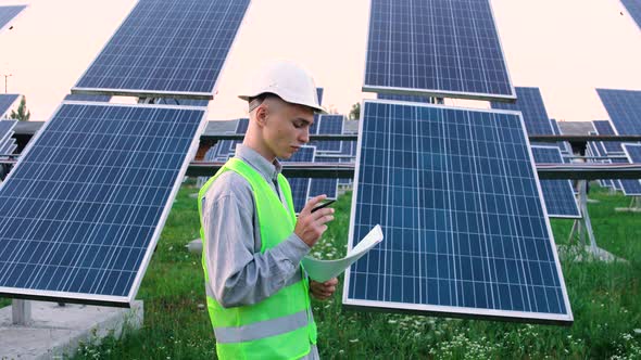 An Engineer Checks the Solar Panels.