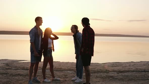 Full Length Footage of a Friends Hanging Out o a Beach Near the Water