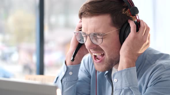 Young Businessman Screaming From Frustration While Working on Laptop at Home