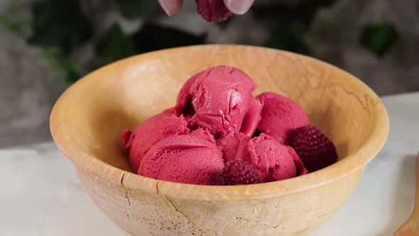 Delicious Raspberry Sorbet in Wooden Bowl