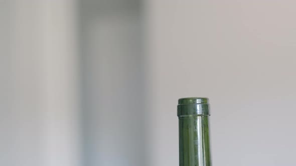 A Hand Closing a Bottle of Red Wine with a Real Cork While at Home