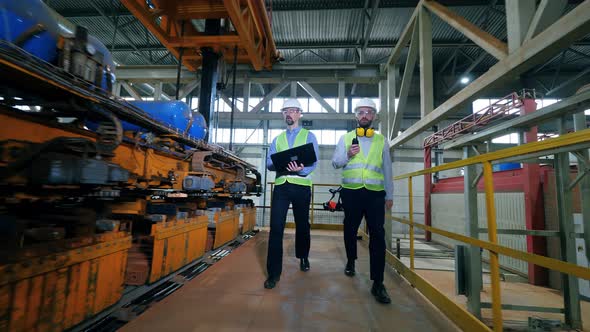 Engineers Walk in a Factory Facility, Checking Brick Factory Machines