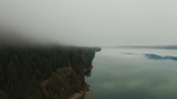 Aerial View of Canadian Mountain Landscape Covered in Fog Over Harrison Lake