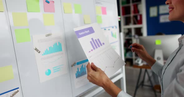 Woman Hanging Document with Graph on Board  Movie Slow Motion