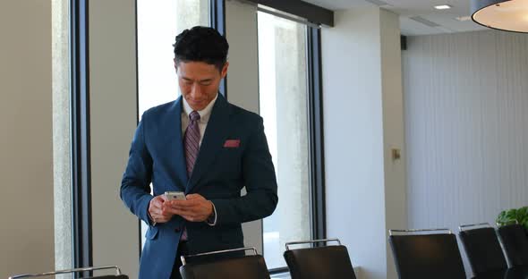 Businessman using mobile phone in office 4k