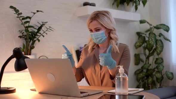 Young Woman Caucasian Wearing Gloves on Hands and Mask on Face While Working From Home