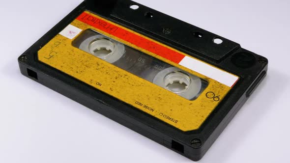 Audio Cassette Rotates on White Background