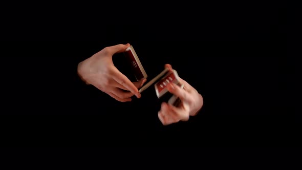 Unusual Trick with Playing Cards on Black Background