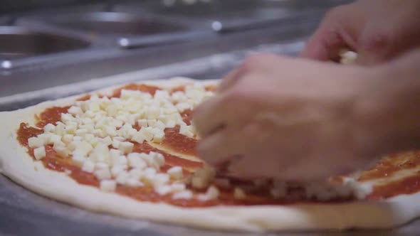 Adding Cheese to Pizza in Slow Motion