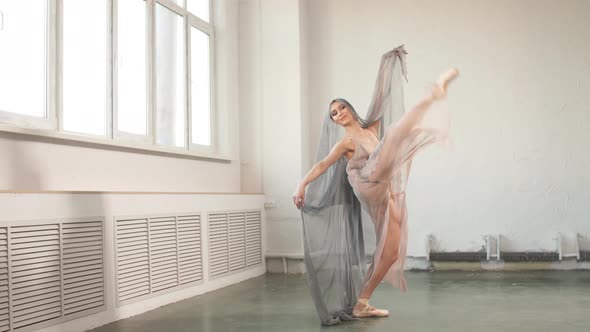 Beautiful Ballerina Dancing with a Flying Veil Isolated on White