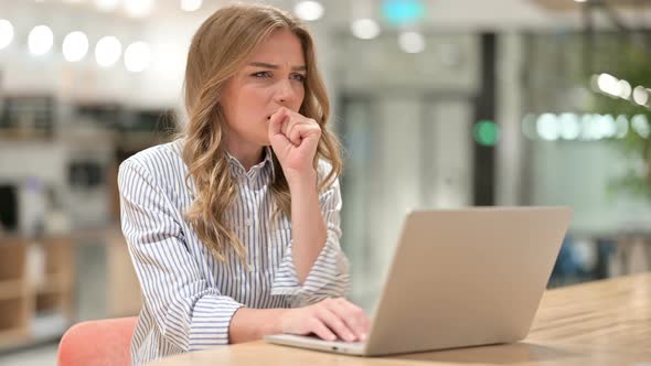 Sick Businesswoman with Laptop Coughing in Office 