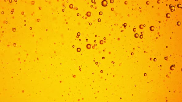 Super Slow Motion Shot of Moving Oil Bubbles on Golden Background at 1000Fps