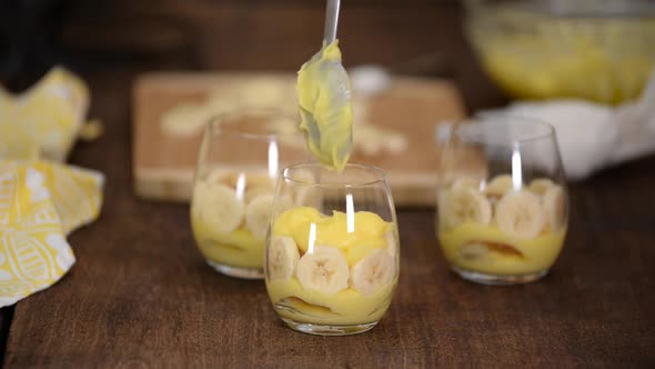 The Girl Making Banana Pudding in Glass Glasses in the Kitchen