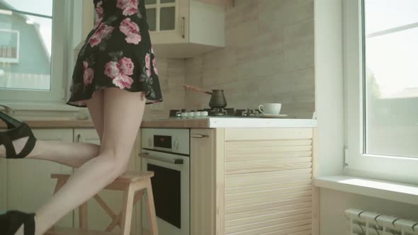 Beautiful Young Brunette Woman In Dress Kitchen At Home