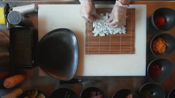 Top Down View of Professional Chef Making Sushi