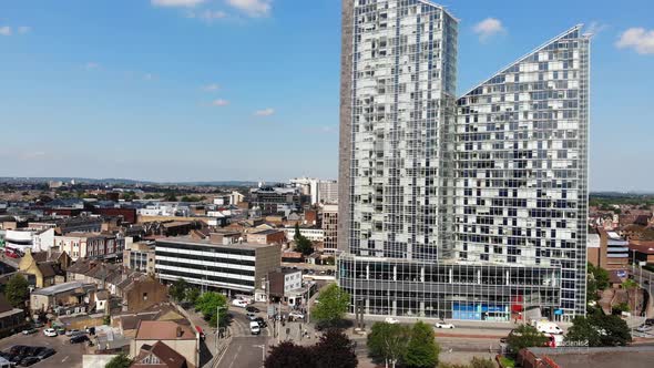 Raising up revealing two tall buildings in Ilford, London on a sunny day