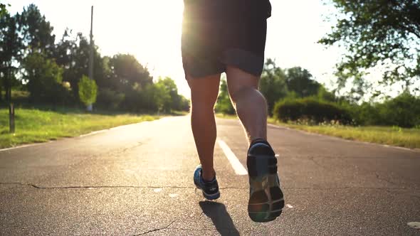 Close Up Athlete Legs Running on Road Fit Runner Jogging Sprinting Endurance Exercise in Park