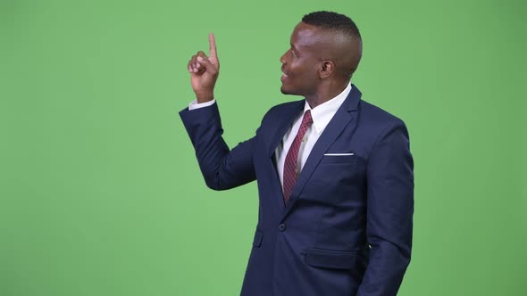 Young African Businessman Thinking While Pointing Finger Up