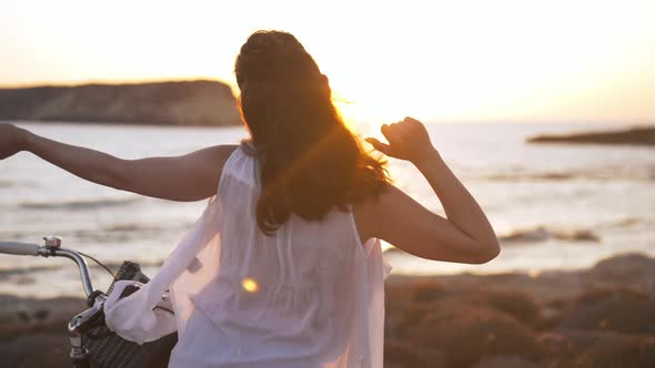 Back View Slim Beautiful Woman Dancing in Sunrays in Slow Motion Smiling Resting at Sunset on Cyprus