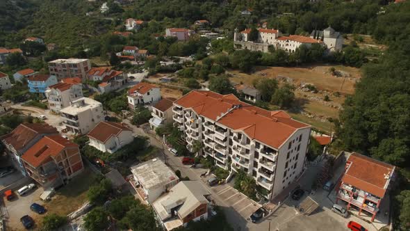 Multistorey Buildings in the Town of Budva Against the Background of the Podmaine Monastery