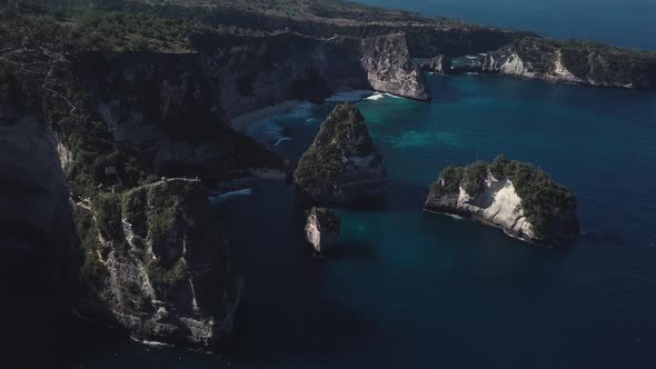 Aerial Fly Over View Of Multiple Tree House Hostels on Cliff 