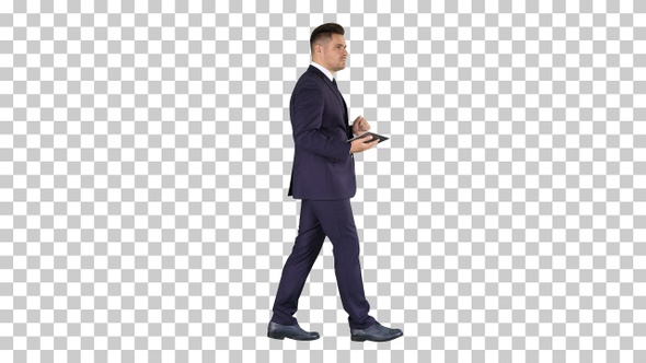 Elegant Young Businessman Using His Pc Tablet While Walking