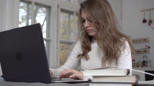 Tired Female Student with a Laptop to Study at Home