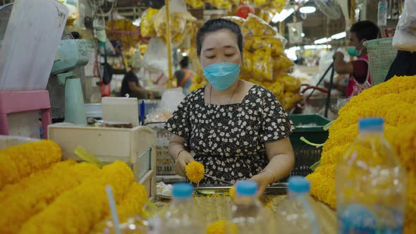 Seller Making Marigold Garlands Inside Pak Khlong Talat Market Amidst Covid19 Outbreak In Bangkok