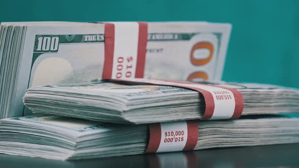 Bundles of Dollars Rotate on Blue Background Heap of Money