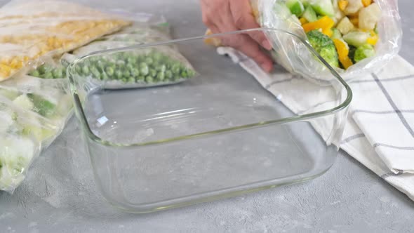 Frozen vegetables in a glass container. Mix of frozen vegetables.
